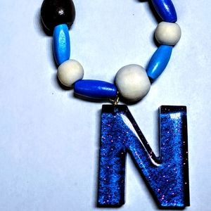 Blue "N" with wooden beads necklace